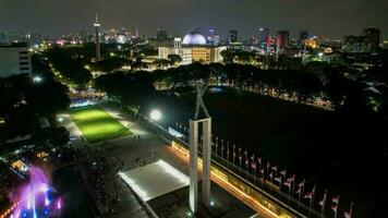 Aerial view of West Irian Liberation monument in downtown Jakarta with Jakarta cityscape. Jakarta, Indonesia, August 29, 2022 photo