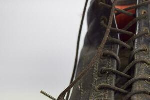 Close up of a brown old boots isolated on white background photo