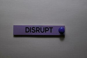 Disrupt text on sticky notes isolated on office desk photo