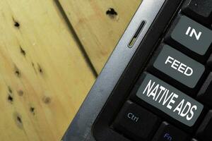 In-Feed Native Ads write on keyboard isolated on laptop background photo