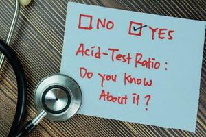 Concept of Acid-test ratio, Do you know it Yes write on sticky notes isolated on Wooden Table. photo