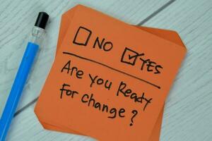 Concept of Are you Ready for Change Yes write on sticky notes isolated on Wooden Table. photo