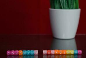 Conflict management text at colorful wooden block on red background. Desk office and education concept photo