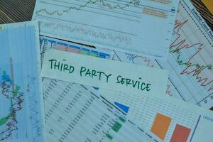 Concept of Third Party Service write on sticky notes isolated on Wooden Table. photo
