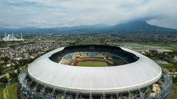 Aerial view of the Beautiful scenery Gelora Bandung Lautan Api  Football or Soccer Stadium in the Morning with Blue Sky. Bandung, Indonesia, November 22, 2022 photo