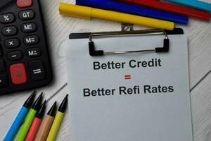 Better Credit equal Better Refi Rates text write on paperwork isolated on office desk. photo