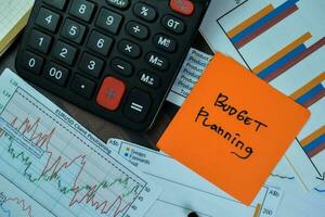 Concept of Budget Planning write on sticky notes isolated on Wooden Table. photo