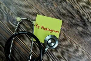 Concept of CT Myelogram write on sticky notes with stethoscope isolated on Wooden Table. photo