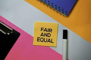 Fair and Equal text on sticky notes with color office desk concept photo