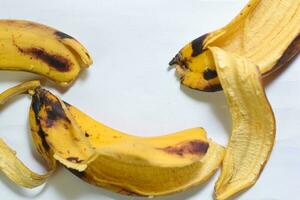 Close up yellow banana peel isolated on white background photo