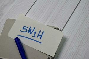 5W1H write on sticky notes isolated on office desk photo