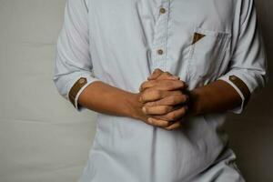 Close up Asian man shows hand gestures it means human emotion and expression isolated on white background photo