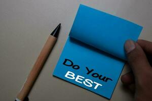 Do Your Best write on a sticky note isolated on office desk. photo