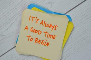 It's Always A Good Time To Begin write on sticky notes isolated on Wooden Table. photo