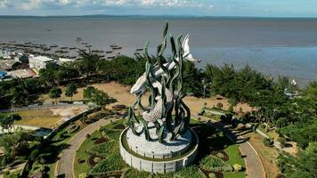 Aerial view of the A giant shark and crocodile statue as a symbol of the city of Surabaya. A landmark or monument as an icon of Surabaya city. East Java, Indonesia, August 28, 2022 photo