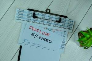 Concept of Deadline Extended write on sticky notes isolated on Wooden Table. photo