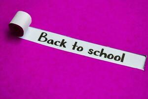 Back to School text, Inspiration, Motivation and business concept on purple torn paper photo