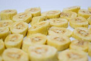 Close up slice yellow banana isolated on white background photo