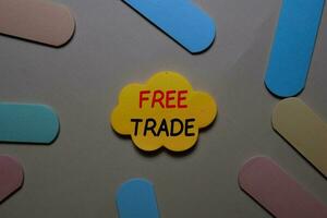 Free Trade write on a sticky note isolated on office desk. photo