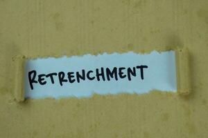 Retrenchment Text written in torn paper photo