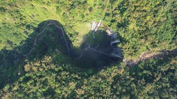 Aerial view of Tumpak Sewu waterfall and Semeru mountain at sunrise located in Lumajang. East Java, Indonesia, August 28, 2022 photo