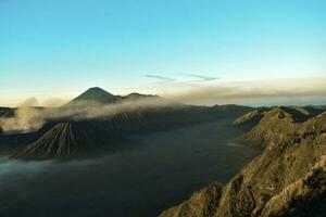 Beautiful colorful sunrise over Mount Bromo and wild island in Mount Bromo National Park photo