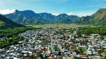 Aerial view of some agricultural fields in Sembalun. Sembalun is situated on the slope of mount Rinjani and is surrounded by beautiful green mountains. Lombok, Indonesia, March 22, 2022 photo