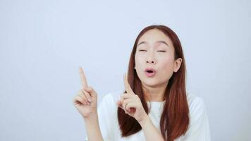 Excited long-haired woman with and pointing at a billboard in the background above. video