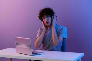 gamer in headphones in front of laptop entertainment Lifestyle technology photo