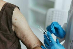 doctor makes an injection in the arm vaccine passport close-up photo