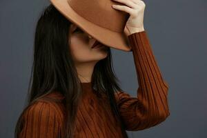 portrait woman in Hat fun brown sweater posing casual wear Gray background photo