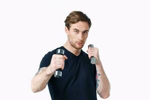 sporty young man with dumbbells on white background workout Copy Space photo