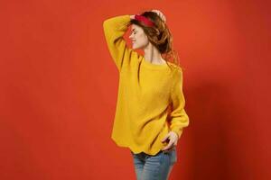 cheerful woman in yellow sweater studio fashion decoration photo