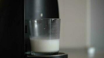 Home capsule coffee machine prepares a cup of fresh cappuccino video