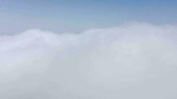 Flying above the clouds over the island of Tenerife - a view of the settlements and the Teide volcano. Canary Islands video