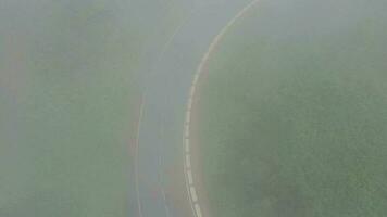 en volant par le des nuages plus de une Montagne route entouré par vert végétation. voitures conduite sur le route video