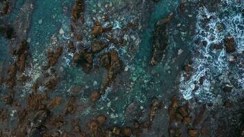 Top view of the surface of the Atlantic Ocean with rocks protruding from the water off the coast of the island of Tenerife, Canary Islands, Spain. video