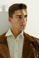 Elegant man wearing brown jacket closeup portrait cropped view photo