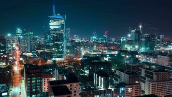 Aerial hyperlapse of Warsaw business center at night skyscrapers and Palace of Science and Culture video