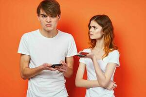 cheerful young couple with phones in hands fashion technology photo