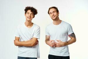 two funny friends in white t-shirts laughing positive emotions photo