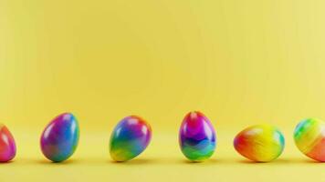 Multicolored Easter eggs rolling on a yellow background. Loop animation video