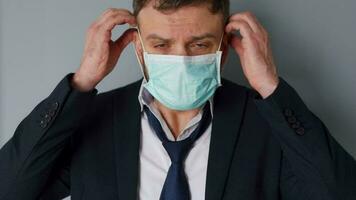 pandemi skydd av de covid-19 coronavirus. trött caucasian man i en skyddande medicinsk mask. begrepp påverkan av de pandemi - arbetslöshet, fattigdom, sjukdom video