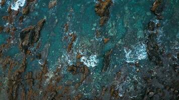 Top view of the surface of the Atlantic Ocean with rocks protruding from the water off the coast of the island of Tenerife, Canary Islands, Spain. video