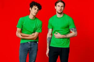 two friends in green t-shirts hold their belly emotions photo