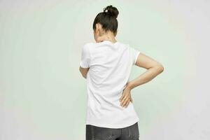 brunette in white t-shirt abdominal pain medicine treatment photo