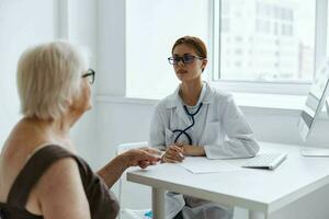 old woman patient talking to a doctor health complaint photo