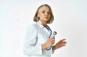 elderly woman doctor in white coat medicine stethoscope photo