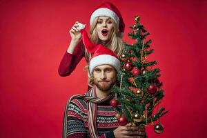 man and woman christmas clothes holiday gift red background photo