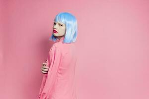 glamorous woman in blue wig pink dress red lips studio model photo